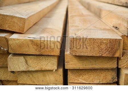 Stacked Lumber. Folded Wood.closeup Wooden Boards.the Surface Of The End Of The Board.lots Of Planks