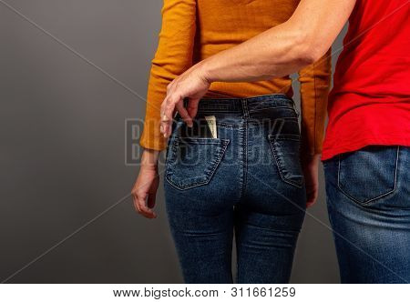 The Thief, Stepping Up Imperceptibly Behind The Girl, Is Trying To Steal A Purse With Dollar Bills F