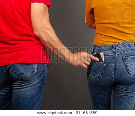 The Thief, Stepping Up Imperceptibly Behind The Girl, Is Trying To Steal A Purse With Dollar Bills F