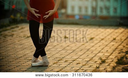Young Woman Ballerina Standing In The Plie Pose On The Roof - Modern Buildings On The Background