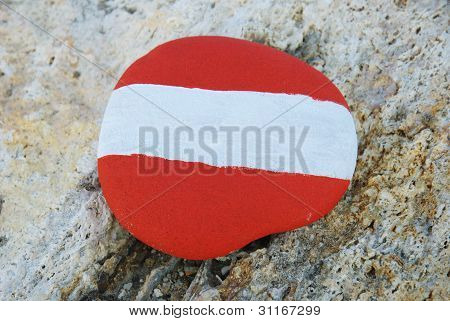 austrian flag colours on a stone