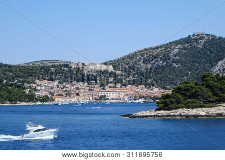 A Faraway View From The Ferry Of The Town Of Hvar, On Hvar Island, Croatia.  It Is A Beautiful Sunny
