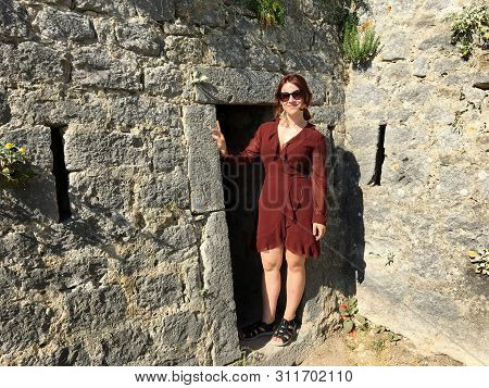 A Beautiful Happy Smiling Young Tourist Standing Beside One Of The Doorways Or Entrances To The Anci