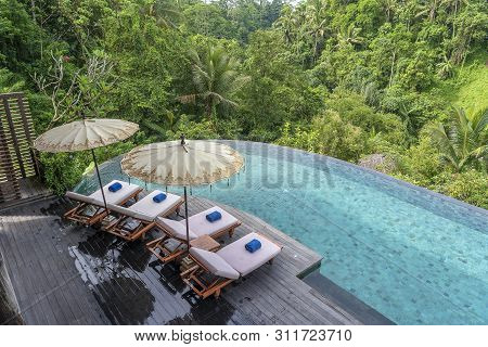View Of The Swimming Pool Water And Sunbeds In The Tropical Jungle Near Ubud, Bali, Indonesia , Top 
