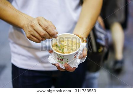 Taipei, Taiwan - 2 Oct, 2017: The Man Holding Famous Local Food Street Traditional Taiwan Noodle Cal