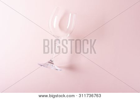 Single Empty Wineglass Lying On Pink Background. Wine Degustation Concept. Flat Lay. Top View. Copy 