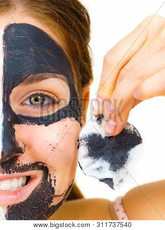 Woman With Clay Carbo Black Mask On One Half Face And White Mud On Second Half. Girl Removing Cosmet