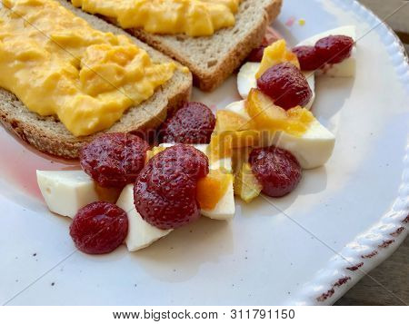 Strawberry Jam With Goat Cheese, Orange Marmalade And Scrambled Eggs In Breakfast Plate. Homemade Or