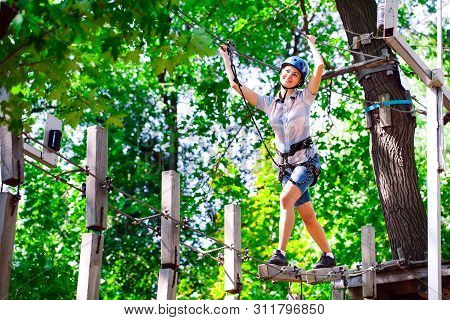Adventure Climbing High Wire Park - People On Course In Mountain Helmet And Safety Equipment