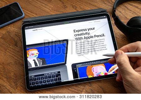 Paris, France - Jun 6, 2019: Man Reading On Apple Ipad Pro Tablet About Latest Announcement Of At Ap