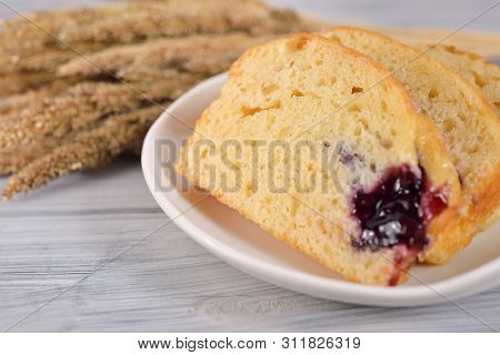 Cliced Butter Blueberry Cake In White Plate On Wooden Gray Background