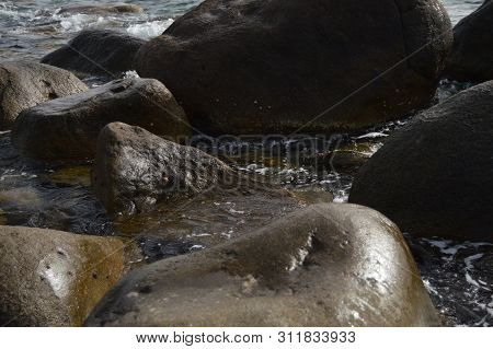 Wet Stones And Rocks On The Shore