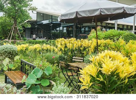 Nakornpathom / Thailand - June 26 2019: Outdoor Chair And Table In Coffee Shop In Tropical Garden