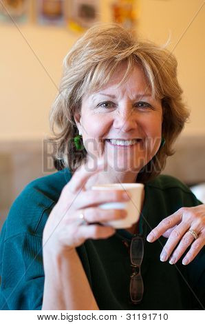 Ältere Frau hält Teetasse