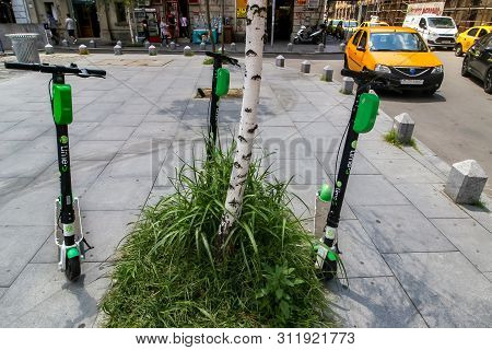 Bucharest, Romania - July 08, 2019: A few Lime-S Electric Scooters are parked on a sidewalk in Bucharest. This image is for editorial use only.