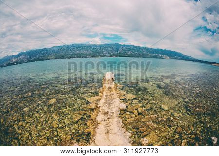 Old Stone Pier On The Adriatic Coast. Sea Coast Of Croatia. Calm Water. Beautiful Places Of European