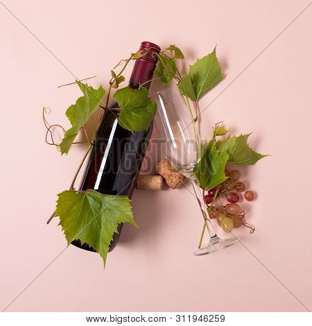 Alphabet. Letter A Made Of Wineglasses With Rose And White Wine, Grapes, Leaves And Corks Lying On P