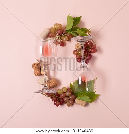 Alphabet. Letter O Made Of Wineglasses With Rose And White Wine, Grapes, Leaves And Corks Lying On P