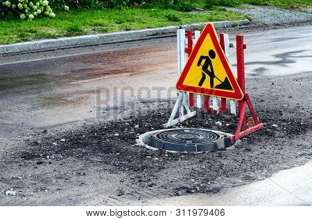 Road Works Traffic Sign At The City Street! Road Under Construction. Sign Fenced Hatch