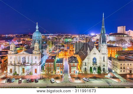 Harrisburg, Pennsylvania, USA nighttime cityscape with historic churches.