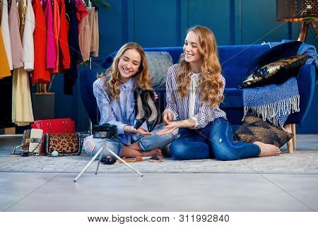 Two Handsome Young Woman Discussing Trends Shoes.