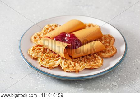 waffles with Norwegian brunost traditional brown cheese and raspberry jam