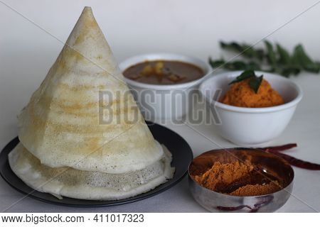 Crispy Thin Ghee Dosa With Sambar, Coconut Chutney And Molaha Podi. Dosa Is Served In Tent Shape. A
