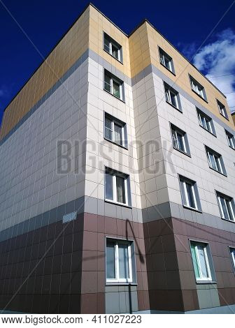 New Multicolored Five-storey House Against Blue Sky.  Residential Building. Housing Construction Con