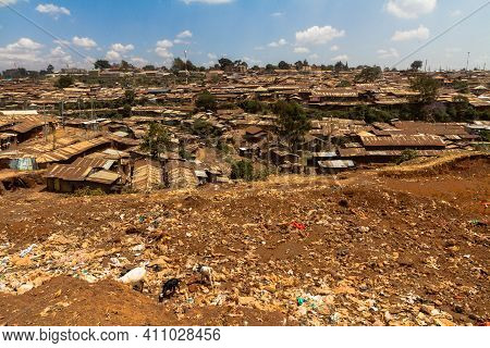 Goats Eat Through A Garbage Pile Next To Part Of The Kibera Slums In Nairobi, Kenya.