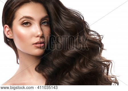 Beautiful Brown-haired Girl With A Perfectly Curls Hair, And Classic Make-up. Beauty Face And Hair.