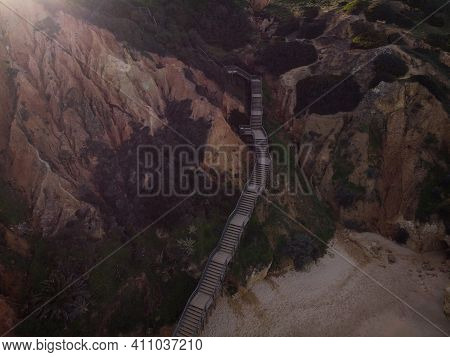 Aerial Top Down Panorama Of Wooden Walkway Stairs Staircase Stairway Leading Down To Praia Do Camilo