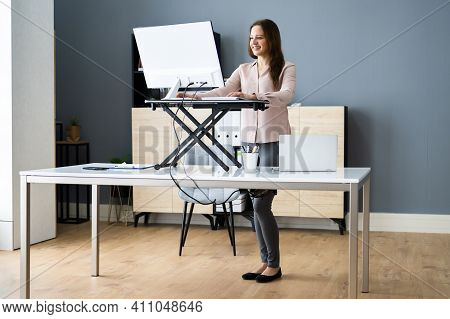 Adjustable Height Desk Stand In Office Using Computer