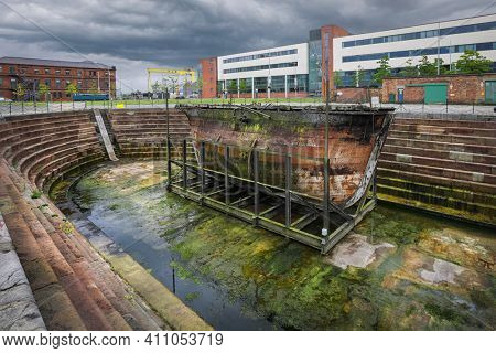 Belfast, Northern Ireland - June 27, 2017: The original caisson gate Hull No 50 stands on beside SS Nomadic at Hamilton Dock is oldest Harland and Wolff vessel anywhere in the world.