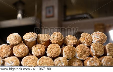 Sweet Puff Pastry Rolls With Protein Cream Are Decorated With Crumbs And Lie On A Tray. Baking In A 