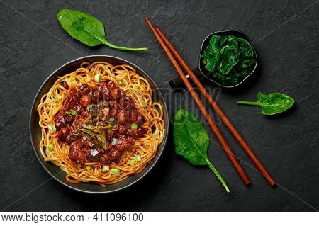 Bakmi Or Mie Ayam In Black Bowl On Dark Slate Table Top. Indonesian Cuisine Noodles Meat Dish. Tradi