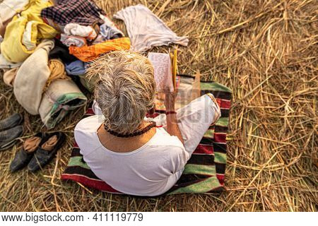 Feburary 2021 Haridawar,india
A Mont Reading The Holly Book During The Kumbh Mela In Haridawar.kumbh