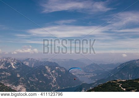 Shot Of An Extreme Athlete Parachuting From The Krippenstein Mountain Part Of The Dachstein Massif. 