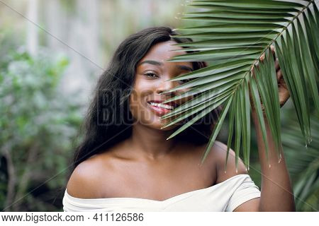 Fashion Tropical Portrait. Young Attractive Dark Skinned Woman Model In White Shirt, Holding In Hand