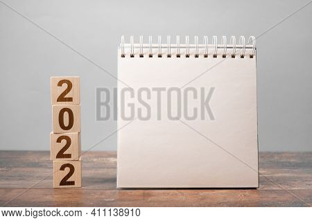 Mockup 2022 Calendar. Text 2022 On Wooden Cubes. Space For Your Text On Notepad, Mockup Calendar. Ne