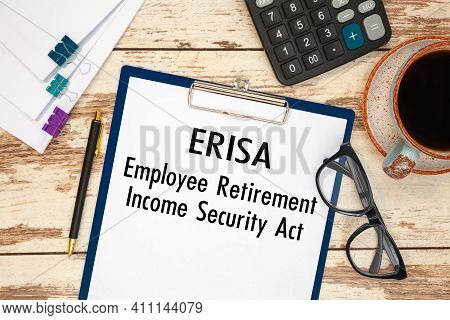 Paper With Erisa - Employee Retirement Income Security Act On The Table, Calculator And Glasses