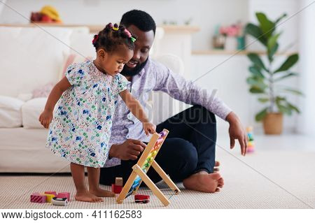 Africam American Family, Father And Daughter Playing With Wooden Abacus And Toys At Home