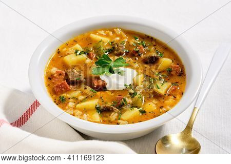 Rassolnik, Beef, Barley, Carrot And Pickle Soup. Cooked In Salty-sour Cucumber Base. Served In White
