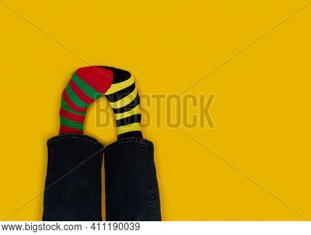 Legs With Different Stripes Socks On Background With Copy Space. World Down Syndrome Day Background.