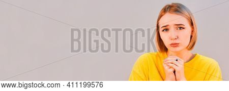 Please, I'm Begging. Portrait Of Woman In Yellow Sweetshot Praying And Asking Heartily, Feeling Desp