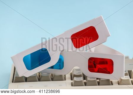 Anaglyph 3d Glasses On Old Pc Keyboard. Blue Background. Retro Attributes 80s