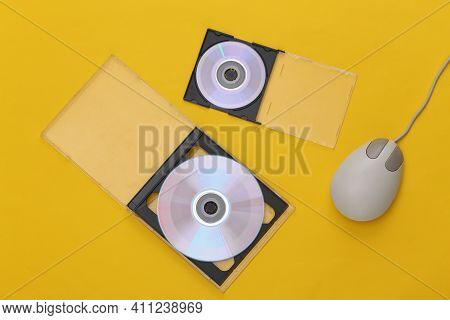 Compact Disсs With Boxes, Retro Pc Mouse On Yellow Background. Top View