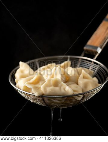 Fresh Boiled Dumplings. Hot Cooked Food Isolated On Black Background. Closeup Shot. Vertical 4x5 For