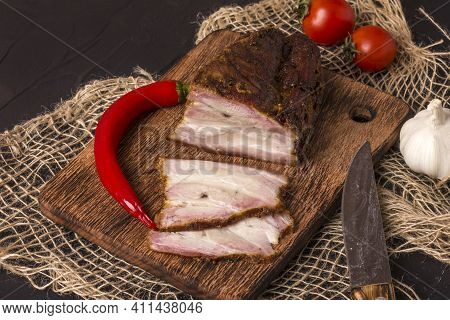 A Piece Of Baked Meat With Layers Of Bacon, Cut From The Bottom Of A Pork Carcass, Along With The Sk