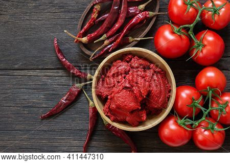 Traditional Turkish Chili Pepper And Tomato Paste In Bowl Or Spoon With Dried Peppers And Fresh Toma