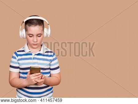 Happy Little Child Listening Music With Headphones. Cheerful Young Boy Listening To The Music In Hea